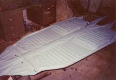 Painting the underside of the 1972 VW Beetle chassis.