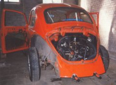 Removing the rear deck-lid from the 1972 VW Beetle.